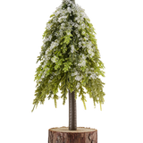 Mini-kunstkerstboom Nordi van 23 cm met ijzige accenten op een voetstuk van een natuurlijke houten schijf, perfect als feestelijke kerstdecoratie.