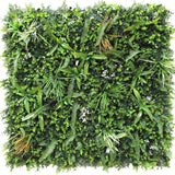 De Kunsthaag mat Savanne 100x100 cm is een vierkant groen wandpaneel dicht bedekt met UV-beschermde kunstvarens, grasachtige bladeren en kleine witte bloemen voor een weelderige, natuurlijke uitstraling in elke ruimte.